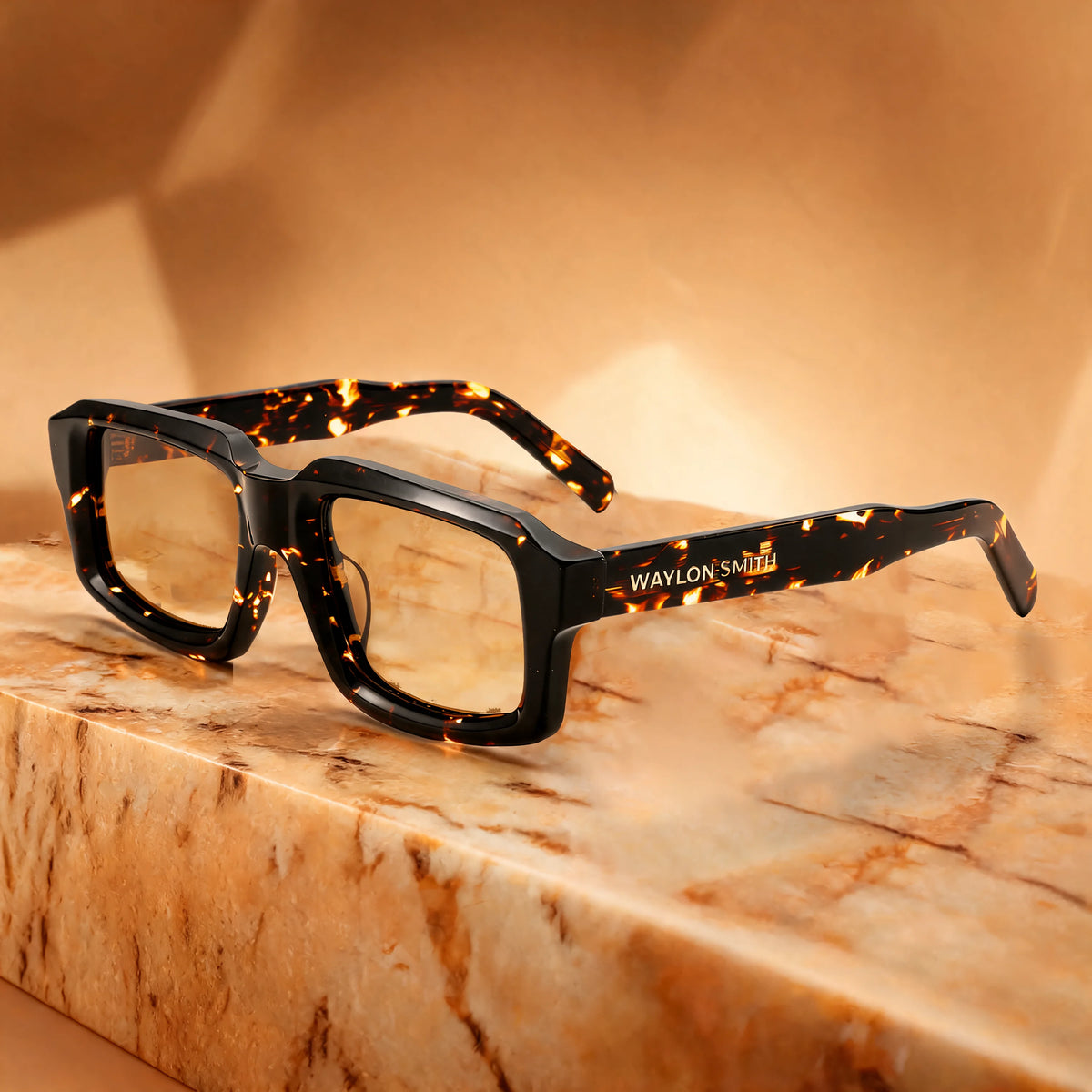 Waylon Smith Syndicate sunglasses in Classic Tortoise resting on a marble surface, showing the Waylon Smith wordmark on the temple