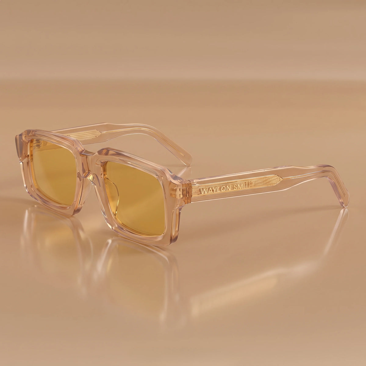 Waylon Smith Syndicate sunglasses in Translucent Amber, studio product shot showing the Waylon Smith wordmark on the temple