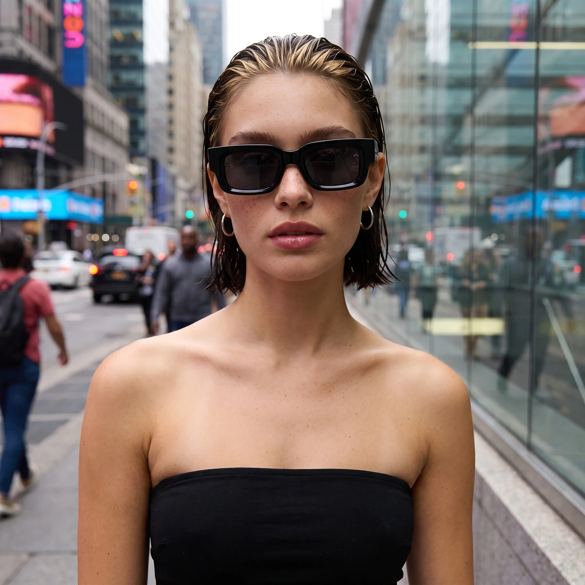 Woman wearing black Waylon Smith sunglasses on a busy city street
