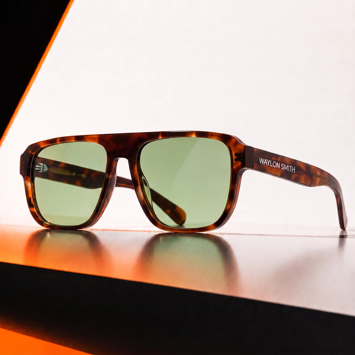 Waylon Smith sunglasses in tortoiseshell with green lenses, studio product shot with dramatic orange lighting