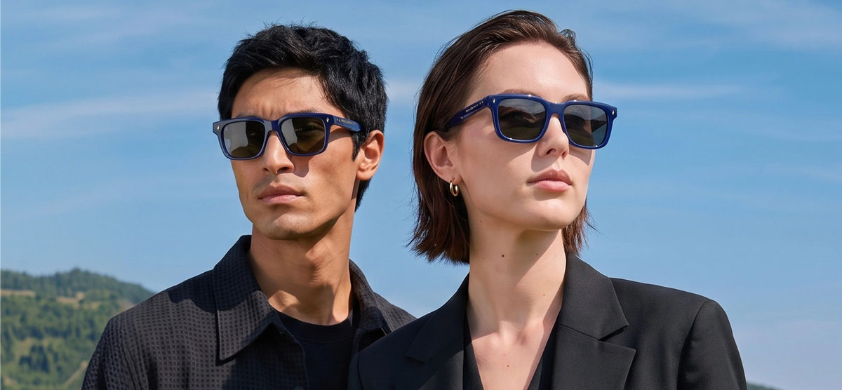 Man and woman wearing navy blue Waylon Smith sunglasses against a blue sky, mobile home page bannerslider_item_fHqR8U