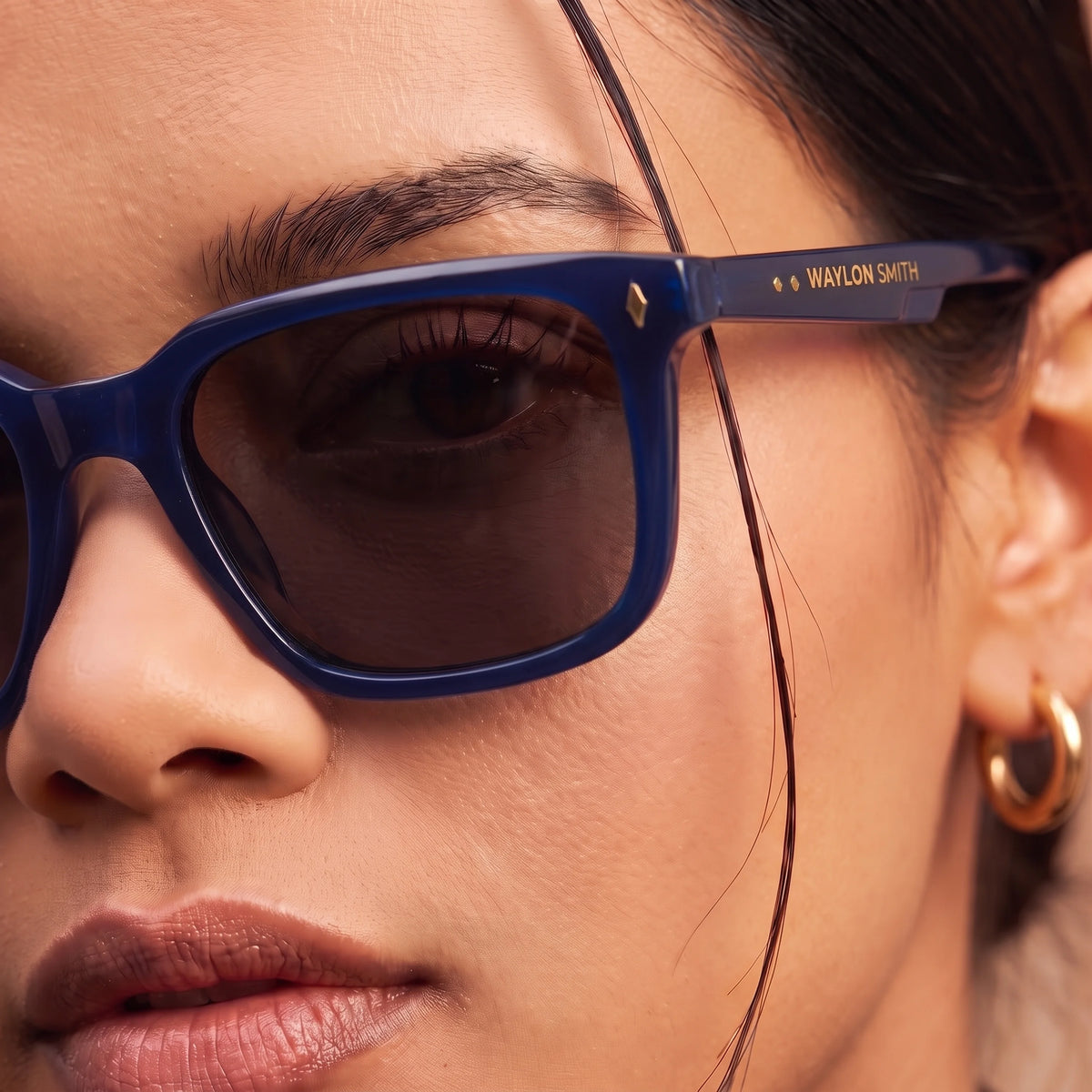 Close-up of Waylon Smith Vinewood sunglasses in blue, showing the Waylon Smith logo detail on the temple