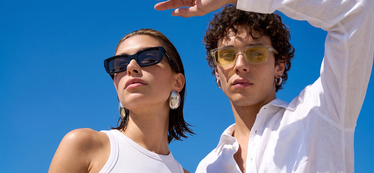 Woman and man wearing Waylon Smith sunglasses against a clear blue sky in casual white outfits, Waylon Smith about page mobile bannerslider_item_hPtTqi